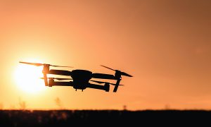 drone silhouetted against the sun